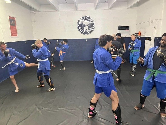 a group of Combat Sambo Athletes in blue uniforms in a gym in Port St Lucie FL